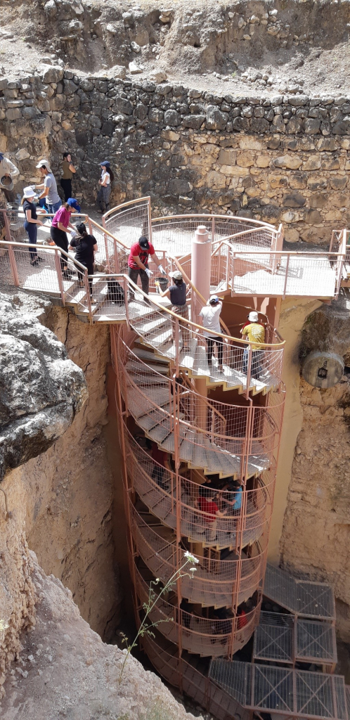 מתנדבים מעלים דליי עפר בשרשרת אנושית במדרגות הספירליות במפעל המים